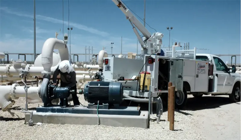 Photo showing Odessa Pumps, a DistributionNOW company, pump technician performing field service on a pump with our field service truck.